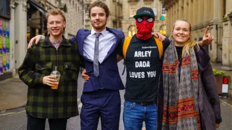 Ben Birchall/PA Milo Ponsford, left, Sage Willoughby, second left, Jake Skuse, second right (in mask), and Rhian Graham, right, are accused of criminal damage