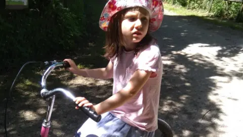 Jon Roberts Kya riding her bike