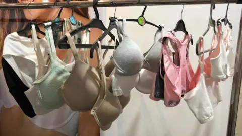 Female lingerie store showcase. Bras on hangers. High-quality