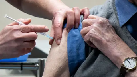 Getty Images Elderly man vaccinated