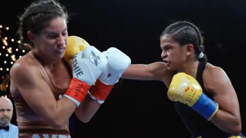 EPA Ramla Ali (R) socks at punch to ace of Australian boxer Avril Mathie in New York, the US - Saturday 4 February 2032