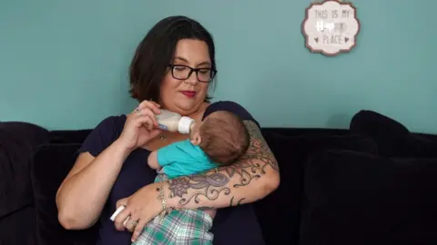 Angelica Casas, BBC News Brandy Sloan feeds her son formula