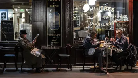 EPA People dine out in Paris on the eve of a second national lockdown in France