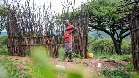 Georgina Smith/BBC Man standing next to crops