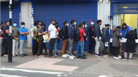 NCP Students queueing outside the Newham Community Project food bank