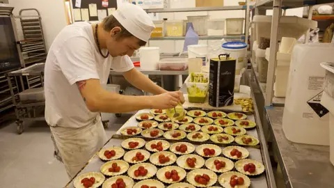 Getty Images A worker makes quiches