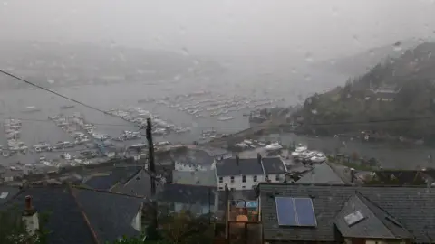 steve1952 Rain falls in Kingswear, Devon. Low mist is over the village.