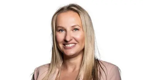 Black Country Chamber of Commerce A woman with straight blonde hair and a peach blazer is smiling at the camera against a white background