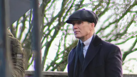 Irish actor Cillian Murphy  wearing his iconic Tommy Shelby costume while filming the upcoming Peaky Blinders movie.