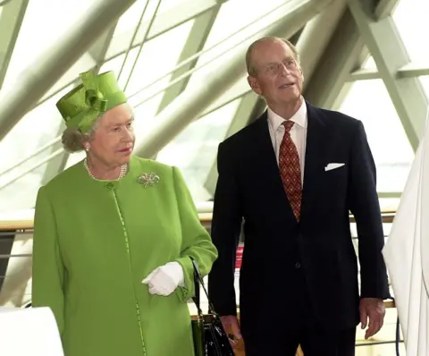 PA Queen Elizabeth II and the Duke of Edinburgh look at the exhibits during their visit to the Science Museum in Glasgow, Scotland.