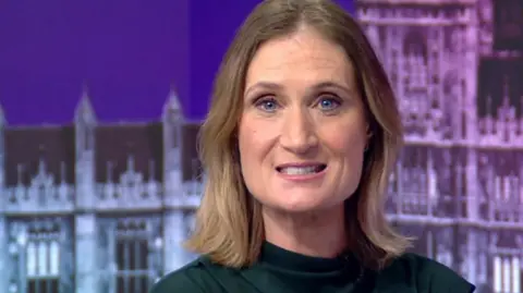 BBC North West Political Reporter Annabel Tiffin sits in front of a backdrop of the Palace of Westminster while hosting the BBC Gorton and Denton by-election debate