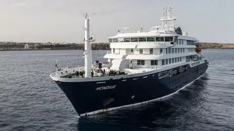 An aerial view of the cruise ship MV Hondius stationary off the port of Praia, the capital of Cape Verde. Photo: 5 May 2026