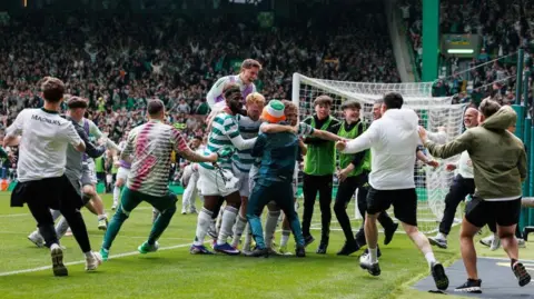 Fans streamed on to the pitch at Celtic Park 