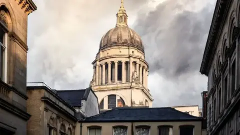 The dome of Nottingham's council house in front of a cloudy sky