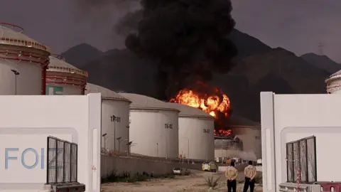 Reuters  Fire and smoke rise in the Fujairah oil industry zone, caused by debris after interception of a drone by air defenses, on 4 March 