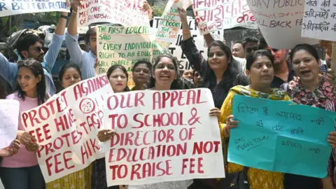 Getty Images Several parents of students studying in private schools in the Delhi area staged a protest against an alleged fee hike in front of the Directorate of Education office at Delhi Vidhan Sabha on April 16, 2025 in New Delhi, India