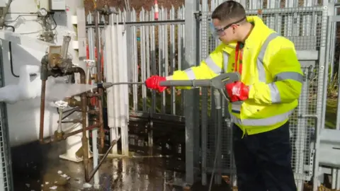 Tonbridge & Malling Borough Council A man involved with the scheme uses a jet machine to clean a piece of equipment