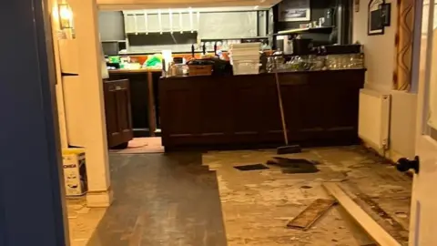 Laura Robinson Floorboards lying on a flood-damaged floor