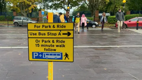 BBC A sign at the entrance of the Royal Derby hospital points people towards a bus stop and the park-and-ride site itself