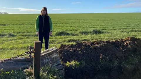 Freya Morgan Freya Morgan beside half-dug ditch