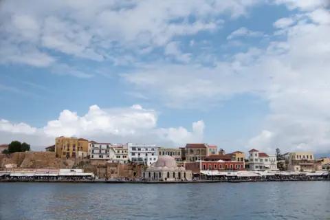 BBC View of the city of Chania in Crete where Ahmed Tarzalakis and his family are staying. At the centre lies Giali Tzamisi, an imposing mosque in the harbour, that used to be one of the earlier buildings of the Ottomans in Crete.