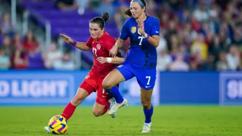 Getty Images Jessie Fleming #17 of Canada and Ashley Hatch #7 of the United States battle for the ball