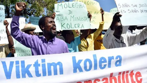 AFP Haitian human rights and victims of cholera in Haiti rally in front of the Log Base of Minustah (United Nations Stabilization Mission in Haiti), in Port-au-Prince, on October 15, 2015