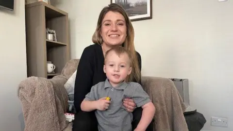 Rebecca Willmont and her son Harry in their home. 