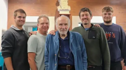 Saltaire World Heritage Education Association A group of five men of different ages stand together smiling.