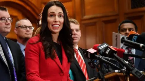 AFP New leader of the Labour Party Jacinda Ardern (C) speaks with her front bench at her first press conference at Parliament in Wellington on August 1, 2017