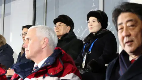 Reuters Mr Pence (L) and North Koreans Kim Yong-nam (C) and Kim Yo-jong (C)