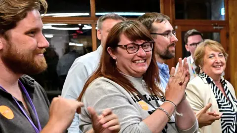 Supporters greet Liberal Democrats party candidate Richard Foord arrives after winning the count for the Tiverton and Honiton by-election, at Lords Meadow Leisure Centre in Devon, UK, on 24 June 2022