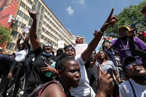 Daniel Irungu/EPA-EFE Kenyan activists shout slogans and hold placards on the streets of Nairobi, Kenya
