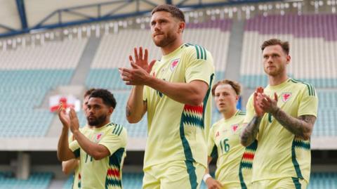 Wes Burns and team-mates applaud Wales' fans in Portugal