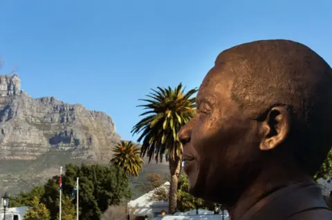 AFP A bronze statue of late South African president and anti-apartheid campaigner Nelson Mandela is seen in the foreground, while the backdrop is Cape Town's distinctive Table Mountain.