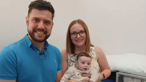 BBC Photo of Sara and Michael Bell and baby Oliver