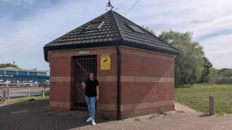 Supplied Carly Booth stood outside a toilet block in Ilkeston