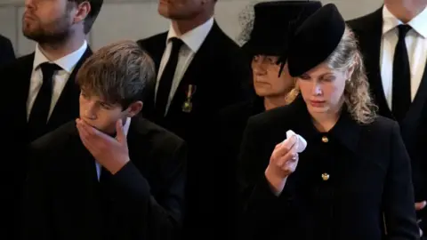 Getty Images James, Viscount Severn, and Lady Louise Windsor pay their respects in The Palace of Westminster after the procession for the Lying-in State of Queen Elizabeth II