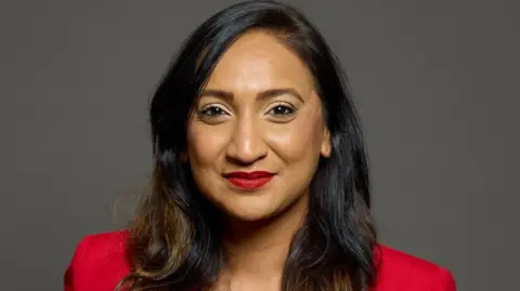 House of Commons Satvir Kaur is pictured smiling at the camera in an official Parliamentary portrait. 