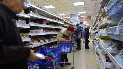 AFP/Getty Images Chinese shoppers in Beijing