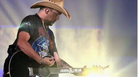 Getty Images Jason Aldean playing guitar