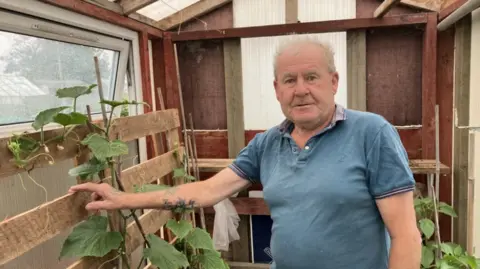 Lara King Bruce Forbes in a shed on his allotment in Carr Lane, Grimsby