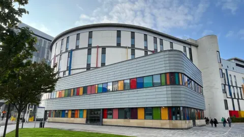 A hospital building with brightly coloured windows