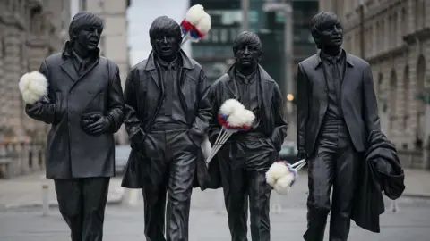 Getty Images Tickling sticks on The Beatles statue