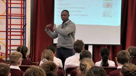 Mr Osei-Appiah giving a school assembly