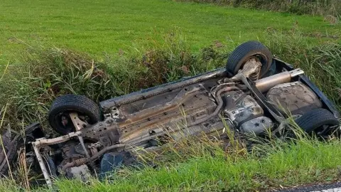 Khalis Islam Car overturned after crashing in a reen.
