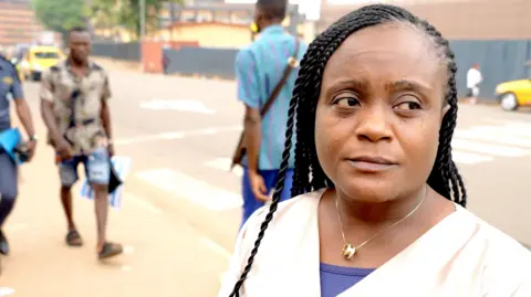 Michel Mvondo / BBC Sylvia Tipa wearing a cream top and long braids