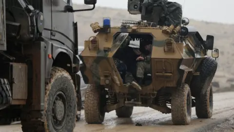 Reuters Turkish forces near Barsaya Hill, north-east of Afrin, Syria (23 January 2018)