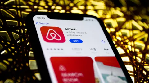 Getty Images A smartphone with the Airbnb app open.