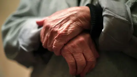 PA Media A close-up image of a pensioner's hands